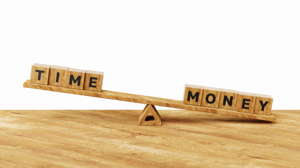 istock More time for less money concept. Long term investment or savings, control or make decision concept. Money over Time. Time and money wooden cubes on seesaw or balance scale. 3d illustration 2169349659