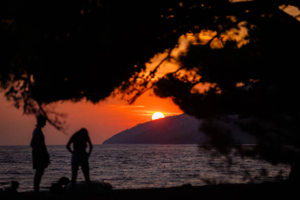 Sun is setting on the sea at Zlatni rat beach.Bol - Brac island - Croatia.