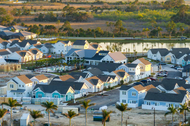 istock Construction in new developing suburban area. Development of residential housing in American suburbs. Real estate market in the USA 2169351390