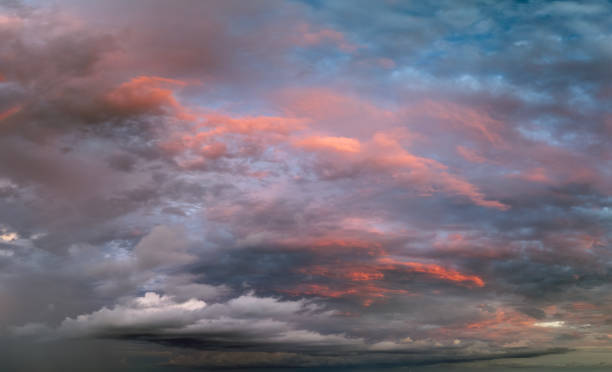 istock Dramatic sunset sky covered with colorful yellow clouds. Panoramic skyscape 2169351421