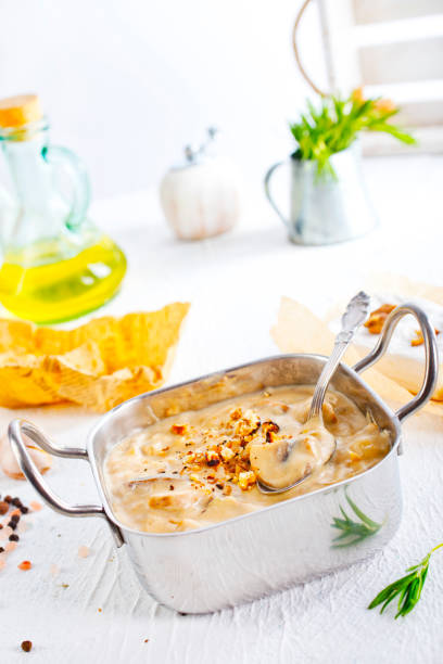Mushroom sauce in metal bowl on white table