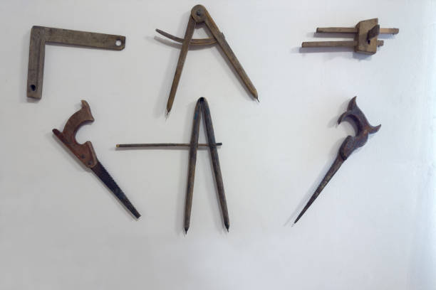 istock Different old wooden carpenter's gauge tools, crosscut saws on wall 2169351868