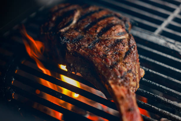 istock Tomahawk steak raw is getting prepared on a cutting board with kitchen knife in background 2169351997