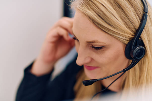 istock Friendly Call Center Agent Answering Incoming Calls with Headset Providing Remote Customer Service. 2169353211
