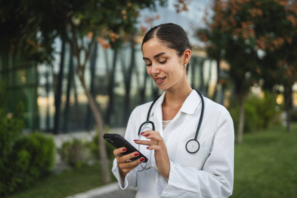istock Woman doctor use mobile phone smartphone while take a brake from work 2169353685
