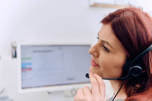 istock Friendly Call Center Agent Answering Incoming Calls with Headset Providing Remote Customer Service. 2169353829
