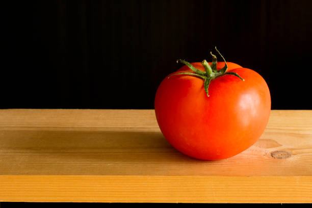 still life of a single red tomato