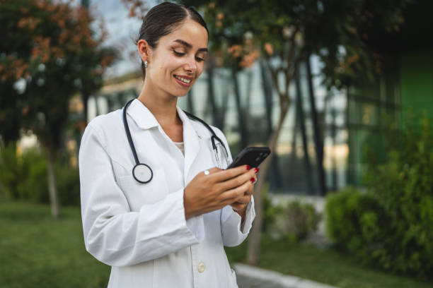 istock Woman doctor use mobile phone smartphone while take a brake from work 2169354078