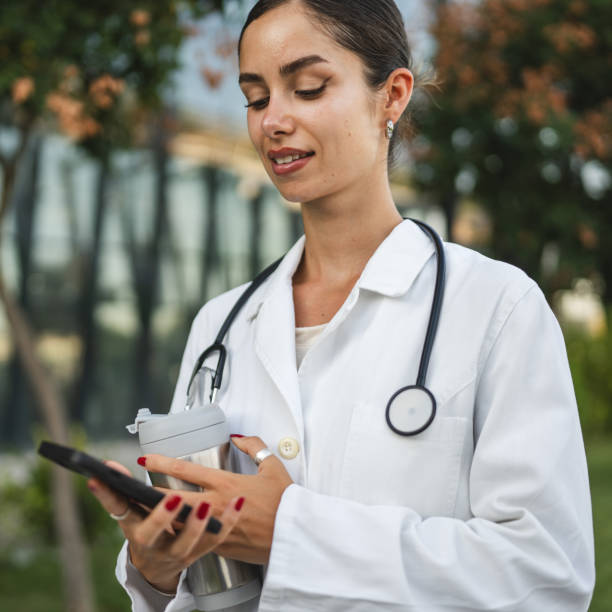 istock Woman doctor use mobile phone smartphone while take a brake from work 2169354920