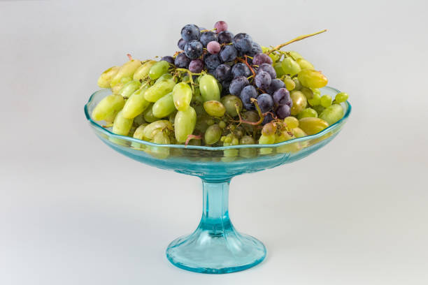 istock White and blue grape clusters on vintage vase on black 2169355065