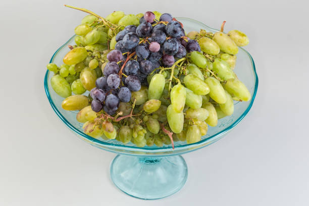 istock White and blue grape clusters on vintage vase on black 2169355088