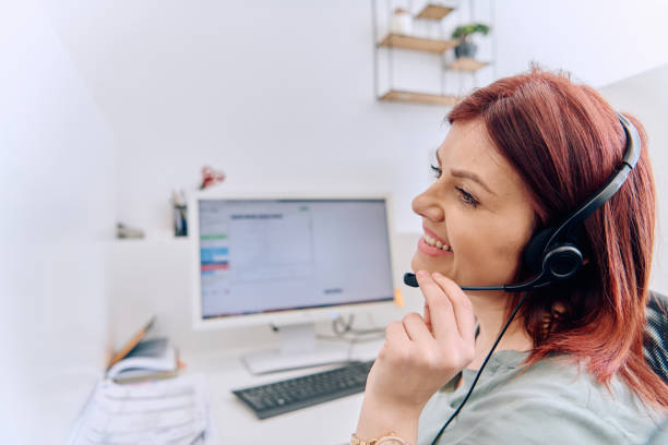 istock Friendly Call Center Agent Answering Incoming Calls with Headset Providing Remote Customer Service. 2169355700