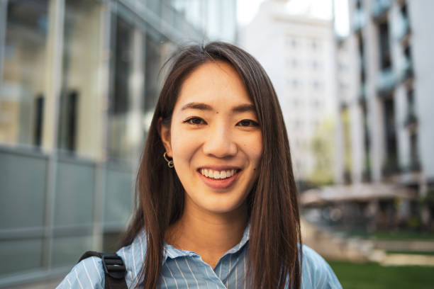 istock Asian woman smiling during her city commute. 2169359612