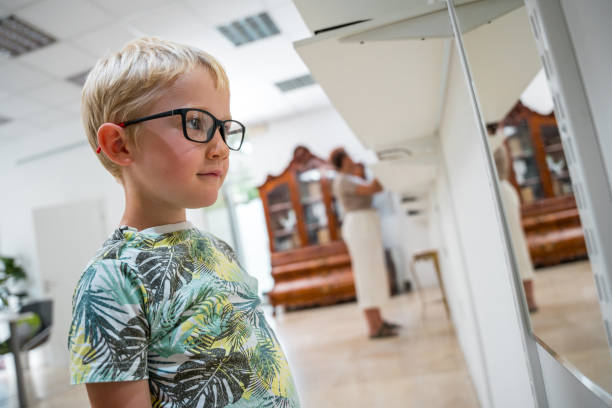 Reflection of a cute little toddler boy, child, looking in mirror, outdoors
