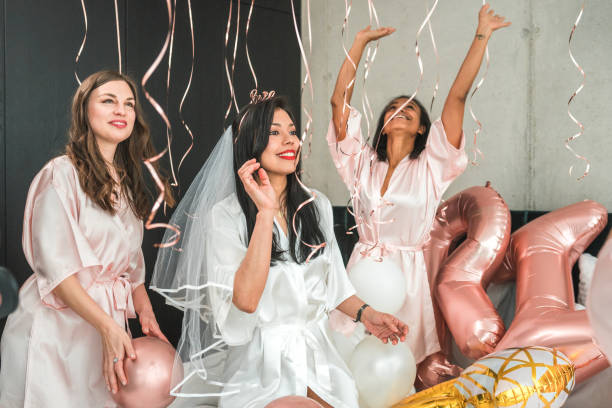 istock Hispanic Bride and Diverse Bridesmaids Having Balloon Fun 2169361661