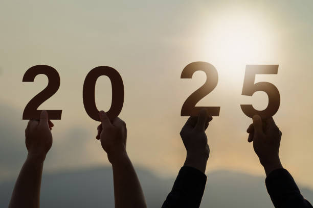 istock New year 2025. start a new year. hands holding text 2025 at sunset. 2169362483