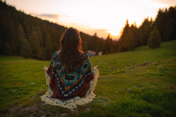 istock Woman with poncho meditating in the mountain 2169363744