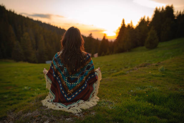 istock Woman with poncho meditating in the mountain 2169363748
