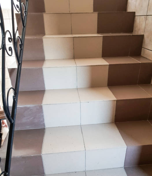 istock Ceramic tiled steps on the stairs inside a modern room, brown and beige color, vertical 2169364827