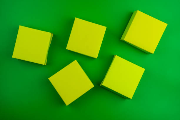 Many of cubes paper box on a green background. Top view