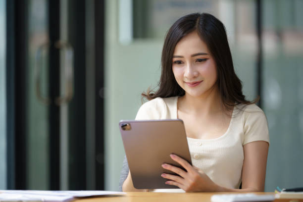 istock Asian female using a digital tablet at the office. 2169373008