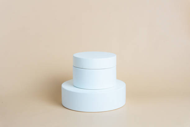 istock White podium on cream background color. Podium for displaying product presentation 2169373088