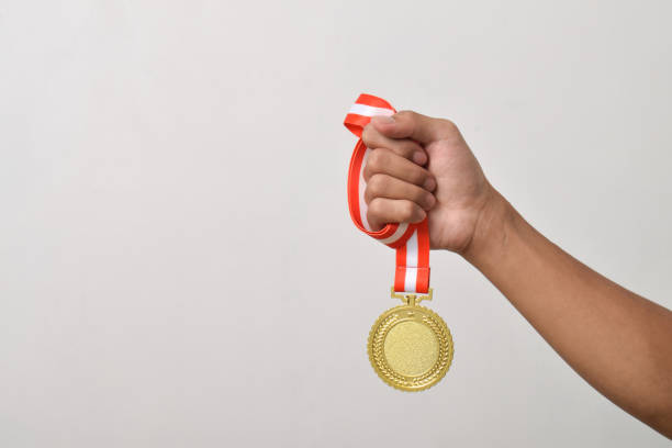 istock Hand holding gold medal. The winner and successful concept 2169373231