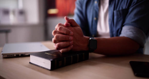 istock Christian Man Hand Praying 2169374314