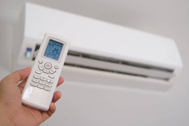 istock Man's hand using remote control open The air conditioner is cooled to 25 degrees Celsius in his bedroom. Health concepts and energy savings 2169374790