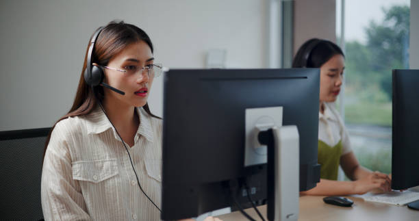 istock Customer service agent team is providing advice to a customer calls at a call center. 2169375314