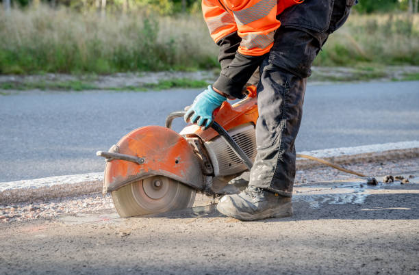 istock construction worker cuts the asphalt with a circular saw on a road 2169377999