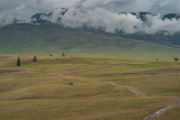 Cloudy landscape of a valley with high mountains. Altai, Kurai steppe