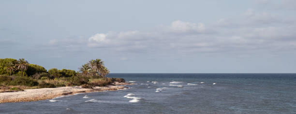 Beach at Cap i Corb cape located south of Alcossebre and belonging to the municipality of Alcala de Chivert (Castellón de la Plana-Spain). Views from an old port warehouse of the XVIII century next to the sea.