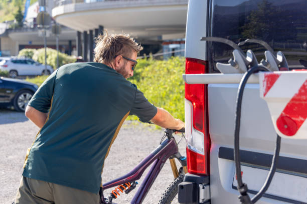 istock Man Preparing Mountain Bike on Camper Van Rack 2169385022