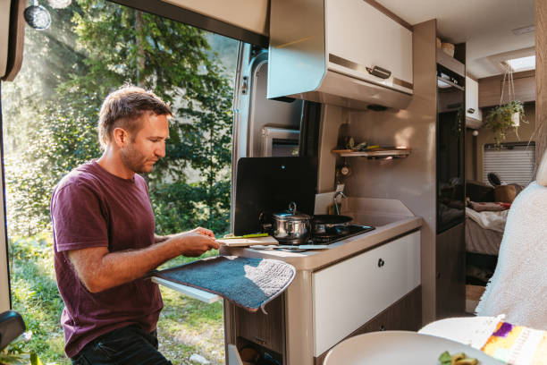 istock Man Serving Food from Camper Van Kitchen 2169385827