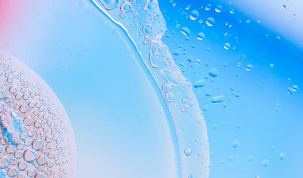 istock Close-up of soft blue liquid with bubbles and droplets, creating an abstract, refreshing 2169388111