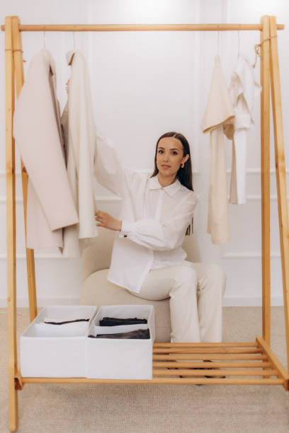 istock A female stylist hangs clothes on a hanger 2169389516
