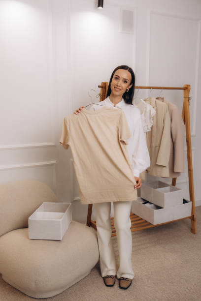 istock A young woman hangs clothes on a hanger 2169389517