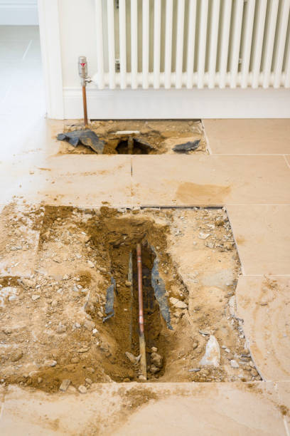 istock Central heating exposed pipework under tile floor, leak repair 2169392075