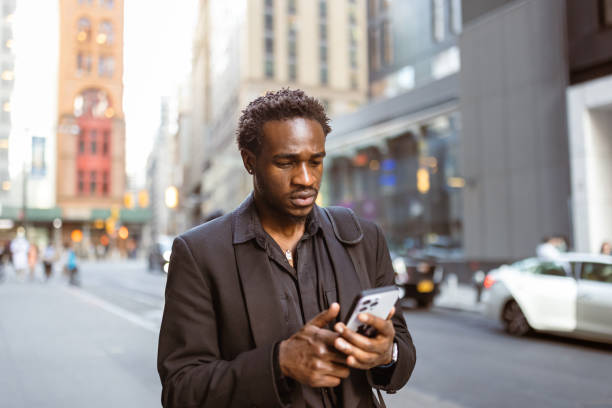 istock Urban Professional Using Smartphone on City Street 2169393983