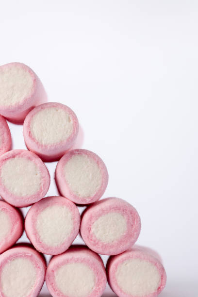 istock Marshmallow pyramid stack positioned to the left, photographed vertically against a white background, highlighting softness and color contrast 2169394020