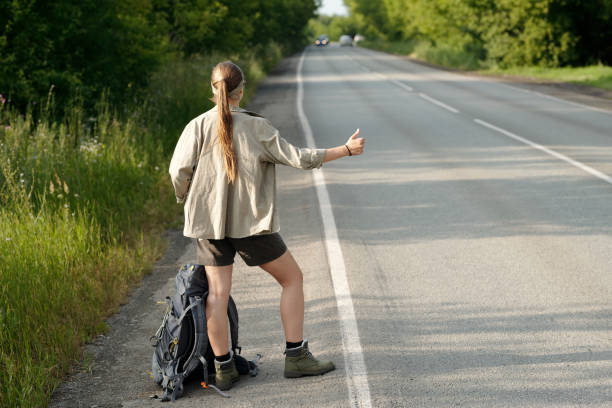 istock Hitchhiker catching car on highway 2169394596