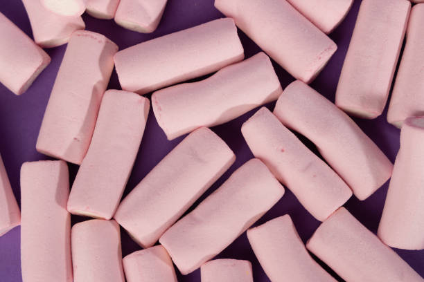 istock Scattered Marshmallows Filling the Frame on Purple Backdrop 2169394786
