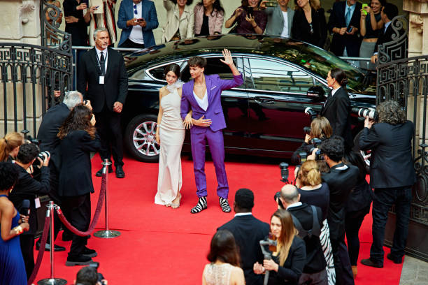 istock Young celebrities arriving by car at red carpet event 2169397715