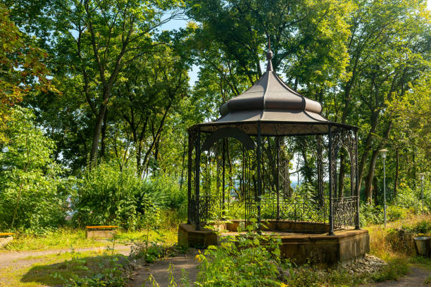 istock small gazebo sits in a lush green park 2169399181