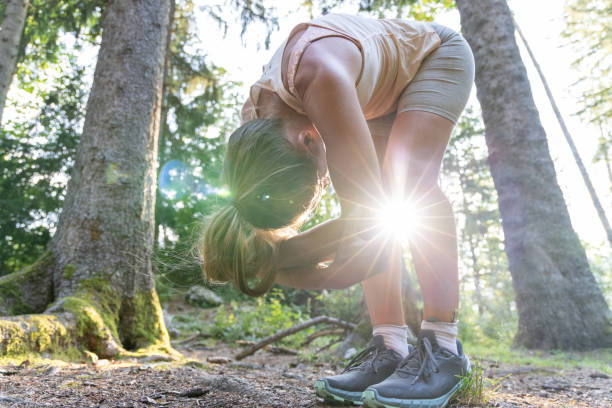 istock Woman Stretching Her Back Outdoors in a Forest 2169403040