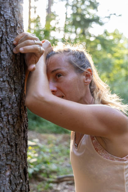 istock Woman Resting Against a Tree After Workout in a Forest 2169403613
