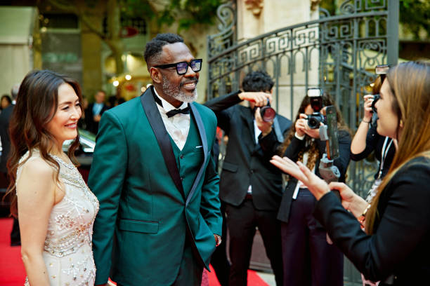 istock Vlogger interviewing celebrity couple at red carpet event 2169406444