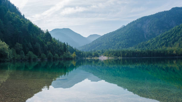 istock Tranquil reflections on the clear waters of Plansee in Austria during a serene summer day 2169409131