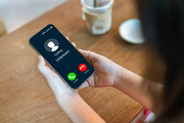 istock Human use smartphone with incoming call from unknown number, spam, prank caller, hoax person, fake identity, scammer, scam with mobile phone, hacker, call center, crime, call, fraud or phishing 2169410864